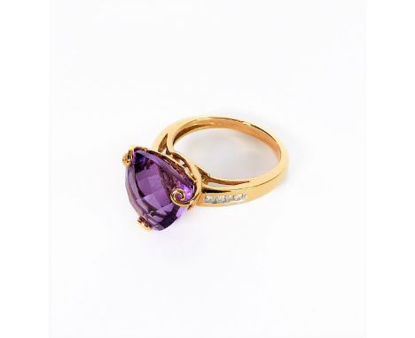 A 9 carat gold ring set with a trillion cut amethyst and with diamond chips to shoulders, size K/M (boxed)