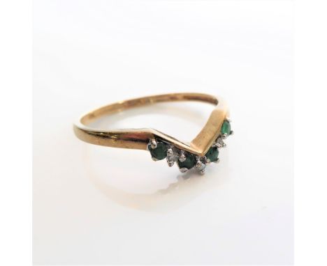 A 9-carat gold ring in a wishbone style set with small emeralds and diamonds, size S (boxed)
