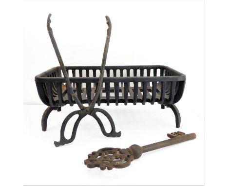 A small fire grate (46 cm wide) together with ironwork tongs and a large decorative early style key.(3)