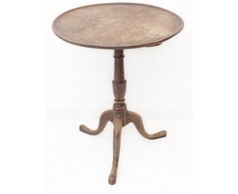 An 18th century circular oak occasional table; turned stem and on tripod base with elongated pad feet (57.5 cm wide x 70.5 cm