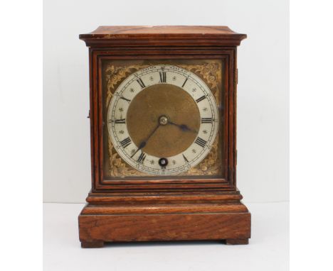 A late 19th century oak cased mantle clock: the chapter ring cornered by gilt metal spandrels modelled as flowerheads and lea