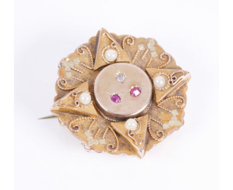 An Edwardian 14ct yellow gold, ruby and diamond plaque brooch: the flower shaped plaque centred by a central boss with a chas