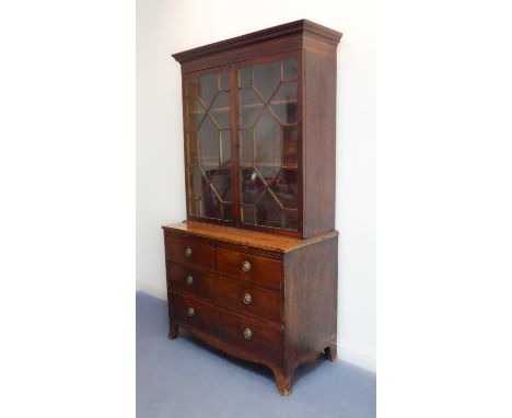 A late 18th century mahogany bookcase on chest: dentil cornice above two 13-pane panel doors with astragal glazing bars enclo