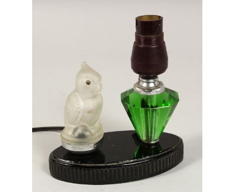 AN ART DECO LAMP, parrot, and scent bottle on an oval base.