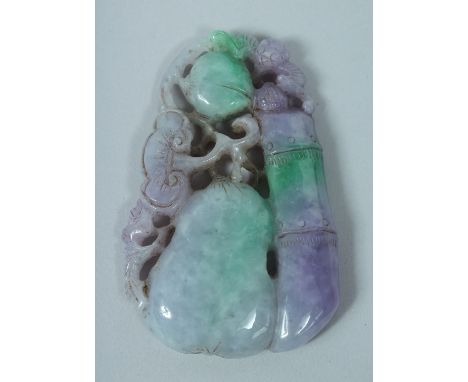 A LARGE CARVED TWO TONE JADE PENDANT 10cm long.