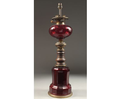 A RUBY GLASS LAMP AND BASE 1ft 9ins high.
