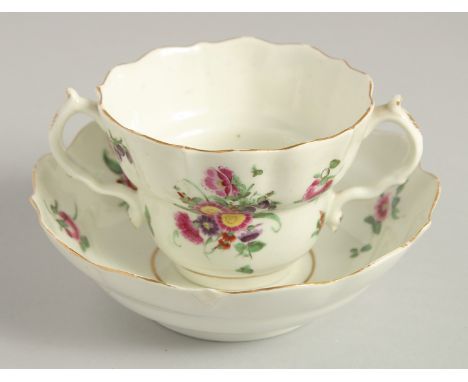 AN 18TH CENTURY WORCESTER POLYCHROME CHOCOLATE CUP AND SAUCER painted with sprays and sprigs of flowers.