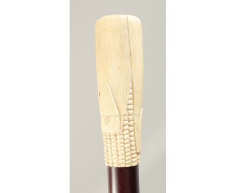 A WALKING STICK with carved bone handle 'CORN ON COB' 2ft 11ins long.