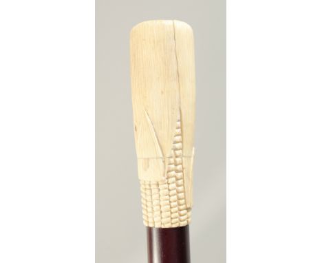 A WALKING STICK with carved bone handle 'CORN ON COB' 2ft 11ins long.