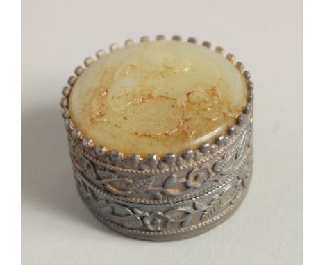 A SILVER AND JADE CIRCULAR BOX. 1.75ins diameter.