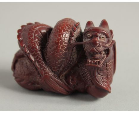 A CARVED WOOD NETSUKE, DRAGON. 2ins.