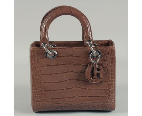 A CHRISTIAN DIOR BROWN LEATHER HANDBAG. No. 43 88 4011949 147. 9.25ins x 7.5ins.