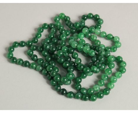 A LONG JADE NECKLACE.