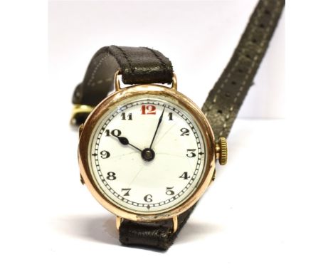 A 9CT GOLD CASED WRISTWATCH  Fitted with a white enamel face, arabic numerals and on a black leather strap, case diameter 2.6