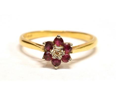 AN 18CT GOLD, DIAMOND AND RUBY FLOWER RING  Hallmarked for London, ring size P ½, weight approx. 2.4g, the flower head measur