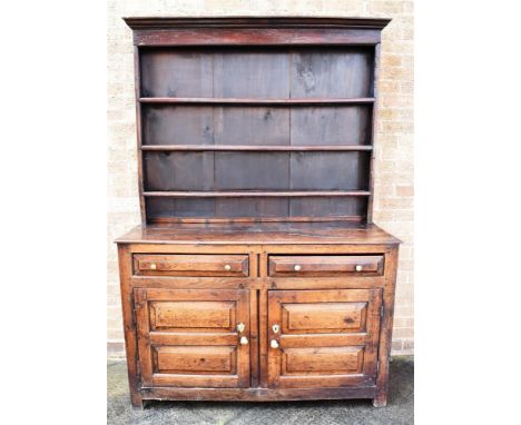 AN OAK DRESSER the upper section having a panelled back and a three shelf plate rack above a base, H 90cm, of two drawers abo
