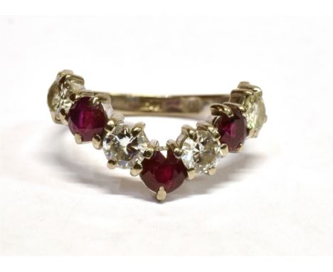 AN 18CT WHITE GOLD DIAMOND AND RUBY WISHBONE RING The ring set with four round cut diamonds alternating with three round cut 