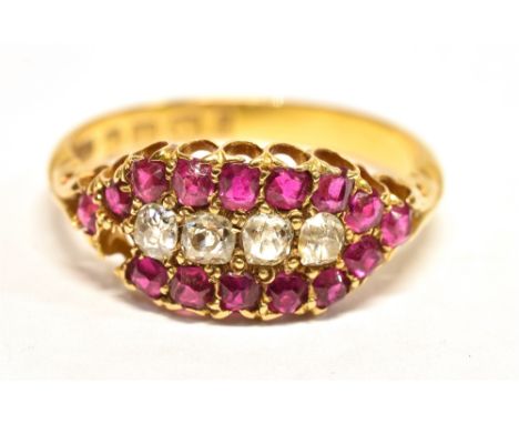 AN 18CT GOLD VICTORIAN DIAMOND AND RUBY DRESS RING  Set with four old mine cut diamonds and surrounded by 15 cushion cut rubi