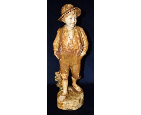 A GOLDSCHEIDER TERRACOTTA FIGURE OF A BOY  wearing a waistcoat, standing with his hands in his pockets, 49cm high, impressed 