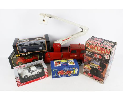 An assortment of diecast and vintage toys. Including a Maisto 'Special Edition' Jaguar XJ 220, a Saturn walking robot, a schu