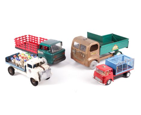 Four vintage toy trucks. Comprising a Tri-ang tipper truck and a Tri-ang milk lorry, a Marx 'Powerhouse Safari Truck', boxed,