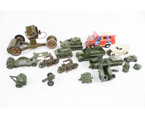 An assortment of diecast military vehicles. Including a Tootsie Toy ambulance, a Dinky tank, lamp truck, two motorcycles, etc