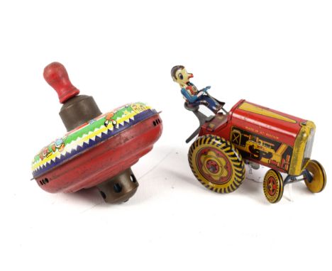 A vintage tinplate Met-Toy clockwork tractor and Chad Valley Spinner. The tractor with orange livery and being driven by a fa