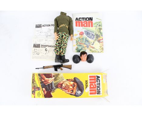 A Palitoy Action Man soldier. With gun, hats and documents, etc, in the original box Condition Report: Head detached