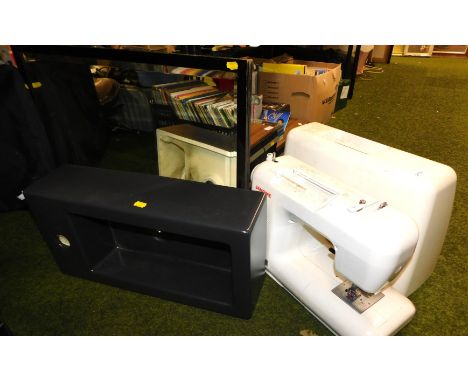A cased sewing machine, together with a black pottery basin, and a wall mirror.