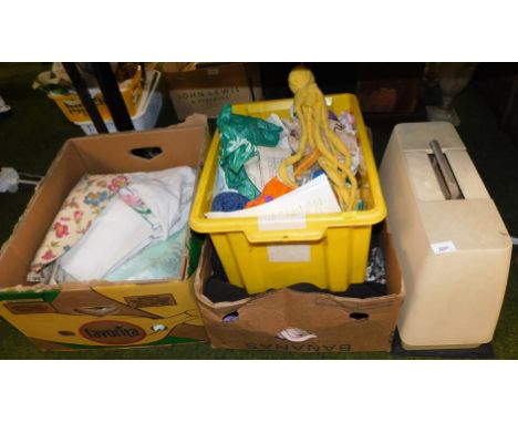 A cased Singer sewing machine, together with worked and unworked fabric, various clothing, yarns of wool, other haberdashery 