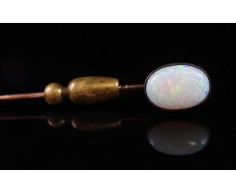 Antique opal stick pin in a unmarked gold setting tests as 9ct and a base metal pin . Approx opal cabochon size 12.2mm x 8.3m