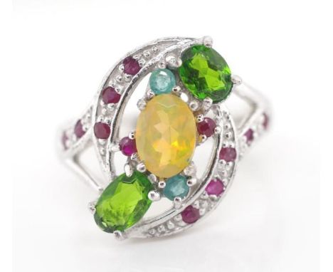 Opal and green garnet set silver ring also set with rubies and emeralds. Approx ring size Q
