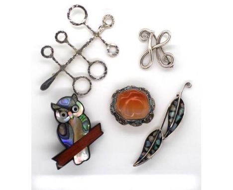 A group of brooches to include hand made silver, opal, carnelian, shell and enamel inlay items.
