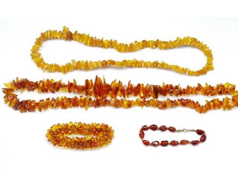 A group of amber beaded necklaces and bracelets from form beads in honey and cognac colours. Approx necklace lengths 72cm and