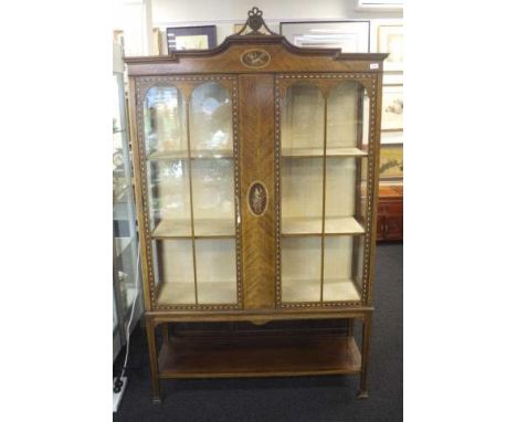 Antique Sheraton display cabinet carved pediment, two glass and panelled doors, banded decoration, opening to lined interior,