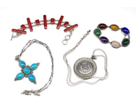 A group of silver and multi gemstone jewellery includes a silver Mayan calendar on chain, a coral set silver bracelet, a turq