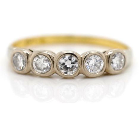 Five stone diamond and 18ct yellow gold ring with a platinum bezel setting. Marked Plat 18ct. Approx weight 1.9 grams, ring s