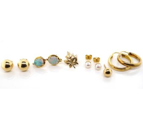 A group of vintage gold earrings includes pairs of hoops, pearl and opal studs as well as singles. Mostly marked 9k or 10k  A