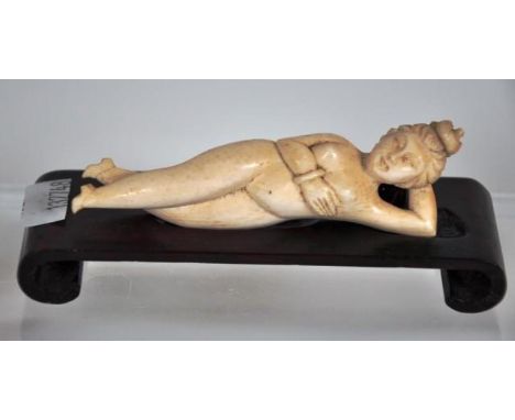 Antique Indian ivory figure of a reclining nude on a timber stand, 9cm long approx., This item cannot be exported.