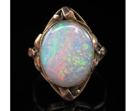 Australian Arts &amp; Crafts Opal and gold ring in the Wager manner, with applied leaf and berry borders. The white opal is s