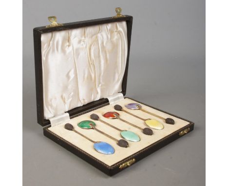 A boxed set of six silver and enamel coffee spoons, with bean finials, in fitted case. Assayed for Birmingham, 1953 by Willia