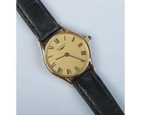 A ladies 9ct gold Longines manual wristwatch. Having champagne dial and Roman numeral markers.  Running.