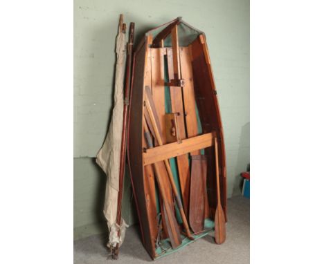 A vintage wooden rowing boat. With oars and mast. Length approximately 230cm.  