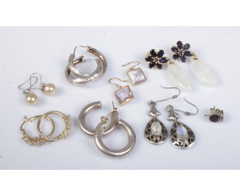 Eight pairs of silver and silver gilt earrings. Includes drop and hoop examples.  