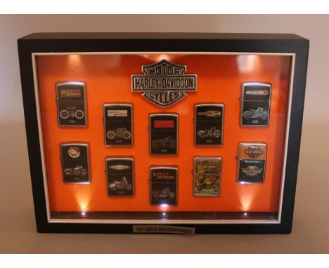 A Harley Davidson cased set of Zippo "100 Years Of American Thunder" lighters, containing 8/10 with 2 other similar Harley Da