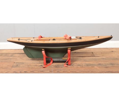 A vintage kit built pond yacht motorised model boat on display stand. Approx. boat length 113cm  Missing sails