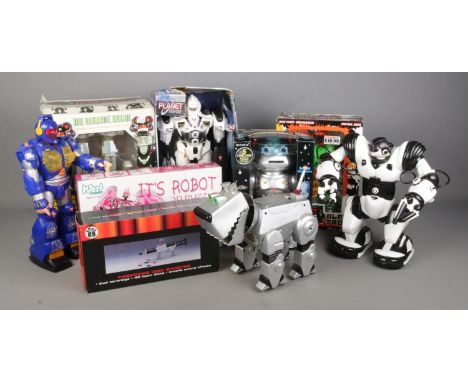 A collection of retro toy robots including Robosapien, Cyberdog, Q-Robot, Disc Shooting Mr Robot, Firepower Disc Shooter etc.
