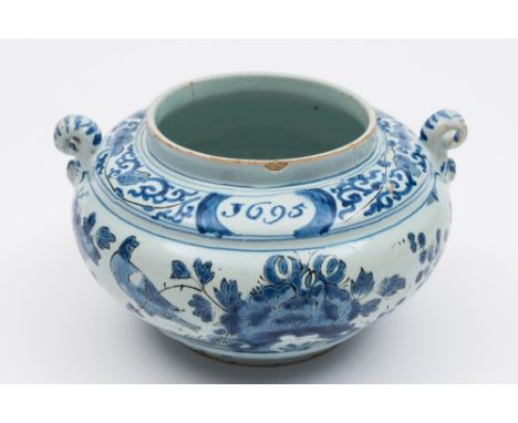 A late 17th century English dated delftware spice jar: of squat globular form with scroll handles, painted in blue with darke