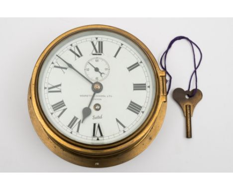 A brass bulkhead clock by Sestral for Negretti and Zambra Ltd, London:, the single barrel movement numbered '43469', white en