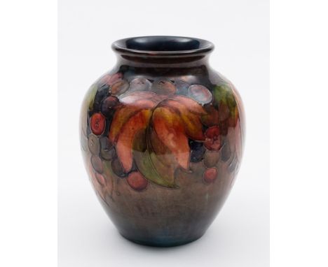 A Moorcroft pottery flambé vase: of oviform tubelined in the Leaf and Fruit pattern in red, orange, purple and green on a fla